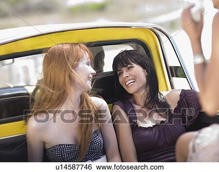 Stock Photograph - Girls having fun on back of pickup. Fotosearch