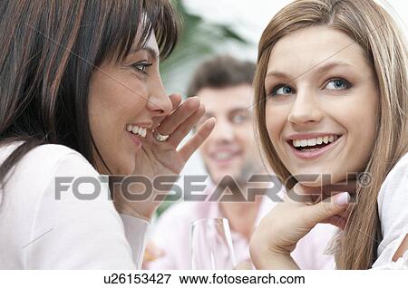 Girls whispering a secret View Large Photo Image Stock Photo - Girls whispering a secret. Fotosearch