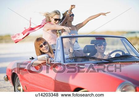 Girls with red scarf riding in cabriolet View Large Photo Image Stock Photo - Girls with red scarf riding in cabriolet. Fotosearch