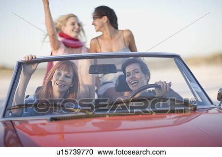 Girls with shades riding their cabriolet View Large Photo Image Stock Image - Girls with shades riding their cabriolet . Fotosearch