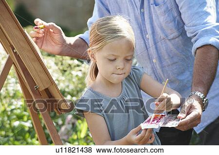 Grandfather and granddaughter painting View Large Photo Image Stock Photo - Grandfather and granddaughter painting. Fotosearch