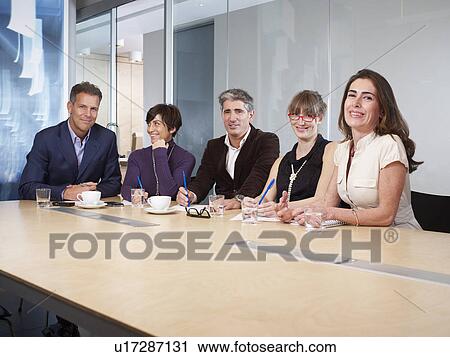 Stock Image - Group Meeting in boardroom. Fotosearch