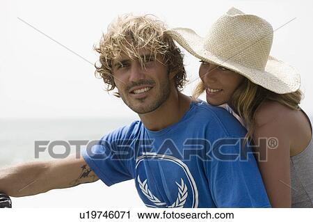 Stock Image - Guy and girl close together, smiling. Fotosearch