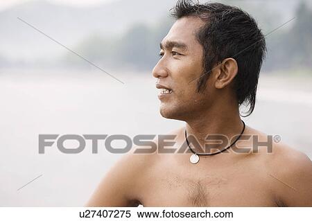 Stock Photography - Guy looking towards ocean. Fotosearch