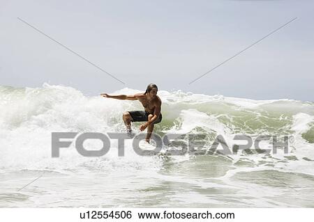 Guy surfing on wave View Large Photo Image Stock Photograph - Guy surfing on wave. Fotosearch