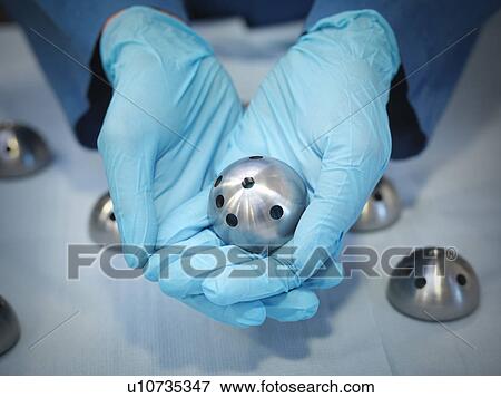 Stock Photo - Hands hold engineered product. Fotosearch