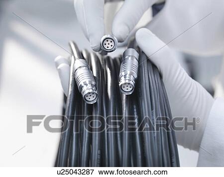 Stock Photo - Hands holding cables and cable ends. Fotosearch