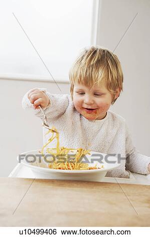 Happy baby boy eating spaghetti View Large Photo Image Stock Photograph - Happy baby boy eating spaghetti. Fotosearch