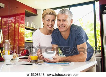 Stock Image - Happy couple at breakfast. Fotosearch