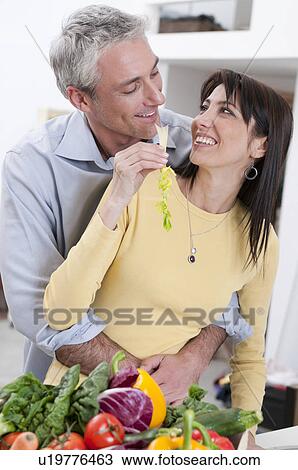 Happy couple eating fresh vegetables View Large Photo Image Stock Image - Happy couple eating fresh vegetables. Fotosearch
