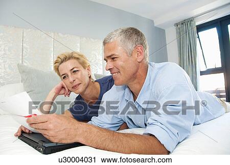 Happy couple look at bills View Large Photo Image Stock Image - Happy couple look at bills. Fotosearch