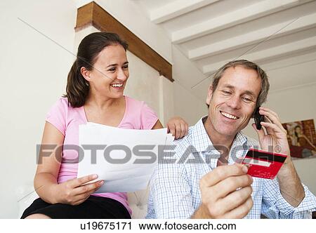 Happy couple pay bill with credit card View Large Photo Image Stock Image - Happy couple pay bill with credit card. Fotosearch