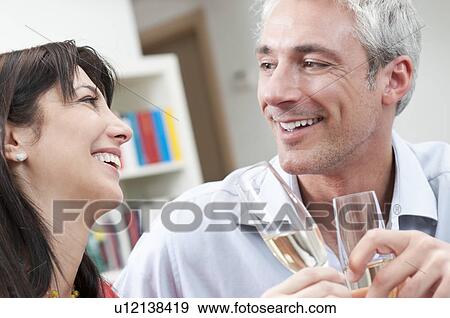 Stock Photo - Happy couple toast wine glasses. Fotosearch