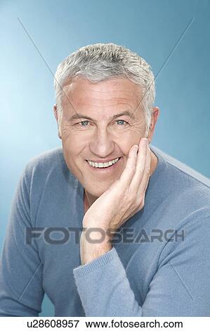 Stock Photo - Happy grey hair man with hand to face. Fotosearch