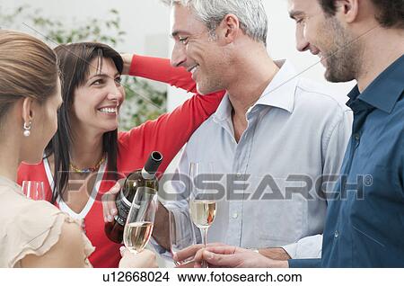 Picture - Happy smiling friends drinking wine. Fotosearch