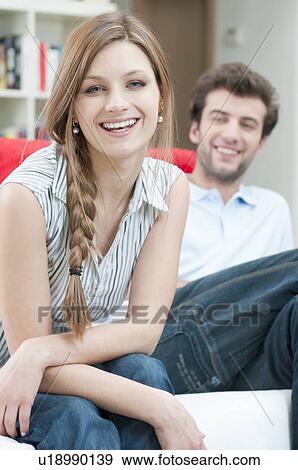 Happy smiling young couple at home View Large Photo Image Stock Photo - Happy smiling young couple at home. Fotosearch