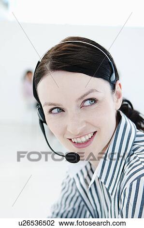 Stock Image - Happy tele sales woman. Fotosearch