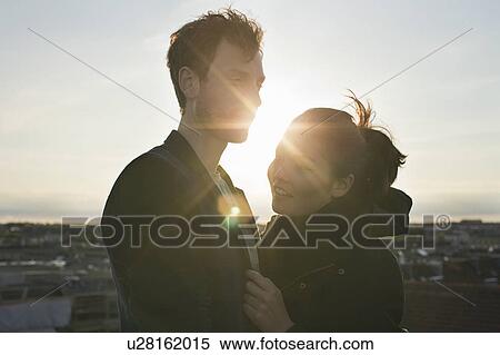 Stock Photography - He gives her comfort and warmth in the s. Fotosearch