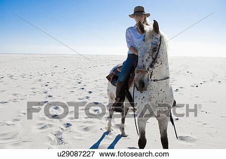 Horseriding in the sand View Large Photo Image Stock Photo - Horseriding in the sand. Fotosearch