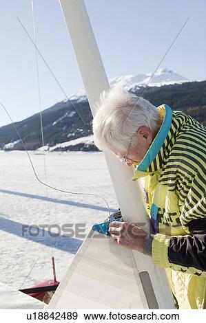 Stock Photo - Ice sailor rigging his boat. Fotosearch