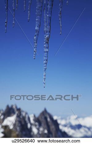 Icicles and snow-covered mountains View Large Photo Image Stock Image - Icicles and snow-covered mountains. Fotosearch