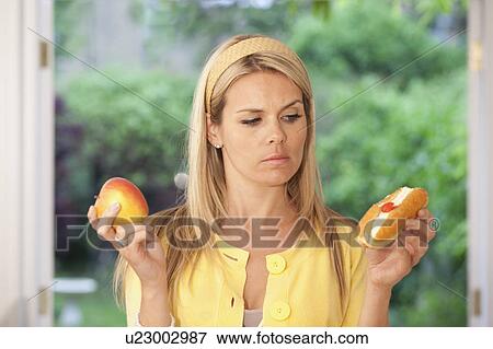 Stock Photo - Indecisive young woman. Fotosearch