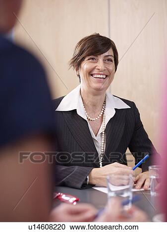 Stock Image - Individuals in a group meeting. Fotosearch