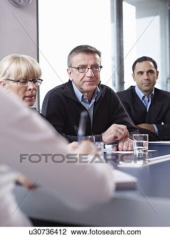 Stock Image - Individuals in group meeting. Fotosearch