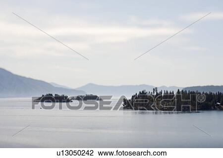 Stock Image - Islands in mountain lake. Fotosearch