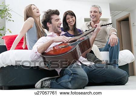 Joyful friends singing and play guitar View Large Photo Image Stock Image - Joyful friends singing and play guitar. Fotosearch