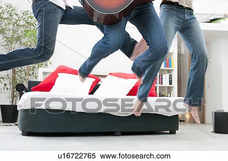 Stock Photography - Jumping together and having fun. Fotosearch