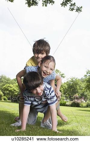 Stock Image - Kids playing in garden. Fotosearch