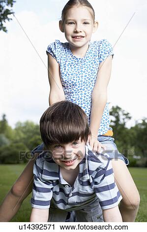 Stock Image - Kids playing in garden. Fotosearch