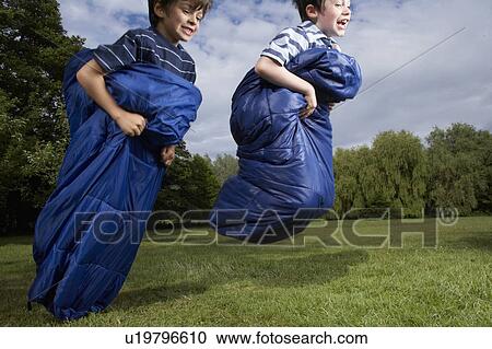 Kids playing in garden View Large Photo Image Stock Image - Kids playing in garden. Fotosearch