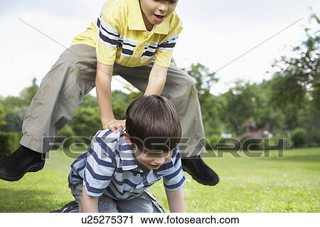 Kids playing in garden View Large Photo Image Stock Image - Kids playing in garden. Fotosearch