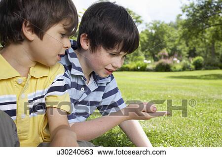 Kids playing in garden View Large Photo Image Stock Image - Kids playing in garden. Fotosearch