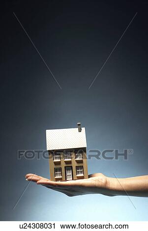 Ladies hand holding model house View Large Photo Image Stock Image - Ladies hand holding model house. Fotosearch