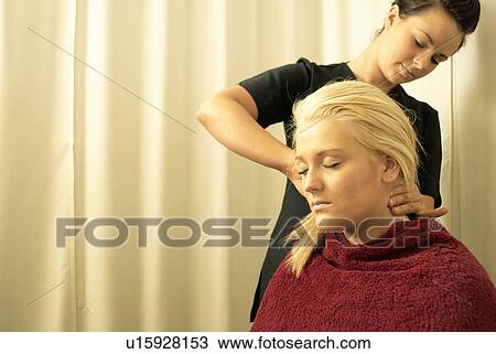 Stock Image - Lady having neck massage. Fotosearch