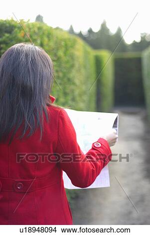 Lady looking at map in a maze View Large Photo Image Picture - Lady looking at map in a maze. Fotosearch