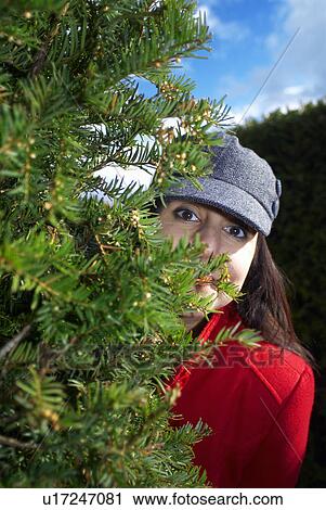 Lady peering around corner of maze View Large Photo Image Stock Image - Lady peering around corner of maze. Fotosearch