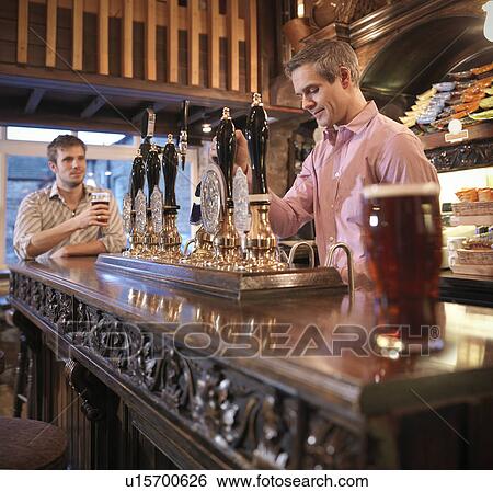 Stock Photograph - Landlord and customer in English pub. Fotosearch