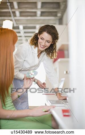 Laughing businesswomen working together View Large Photo Image Stock Photo - Laughing businesswomen working together. Fotosearch