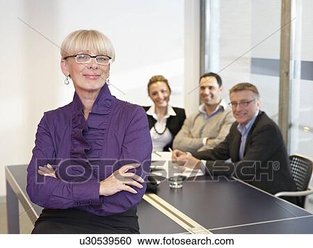 Stock Image - Leading Busines Woman in meeting. Fotosearch