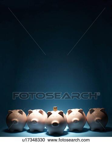 Stock Image - Line of piggy banks one with coins on it. Fotosearch