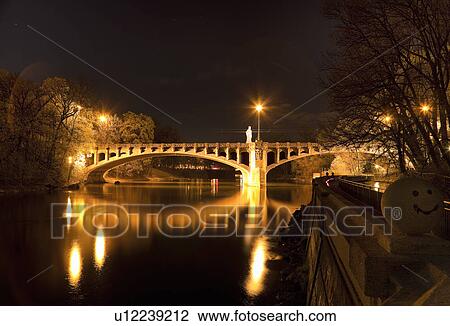 Lit bridge over river at night View Large Photo Image Stock Image - Lit bridge over river at night. Fotosearch