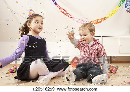 Stock Photo - Little boy and girl with confetti. Fotosearch
