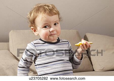 Little boy eating fruit View Large Photo Image Stock Image - Little boy eating fruit. Fotosearch