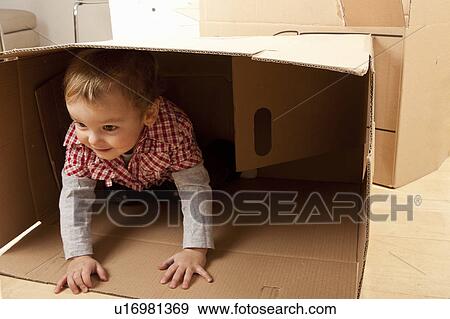 Stock Photo - Little boy in packing case. Fotosearch