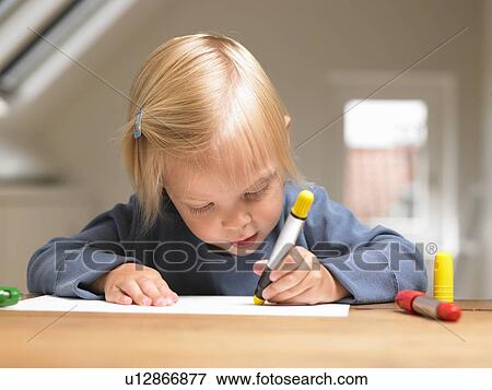 Stock Photo - Little girl drawing a picture. Fotosearch