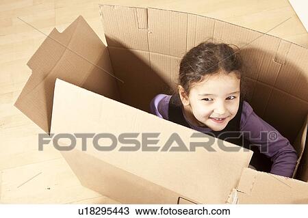 Little girl in packing case View Large Photo Image Stock Image - Little girl in packing case. Fotosearch